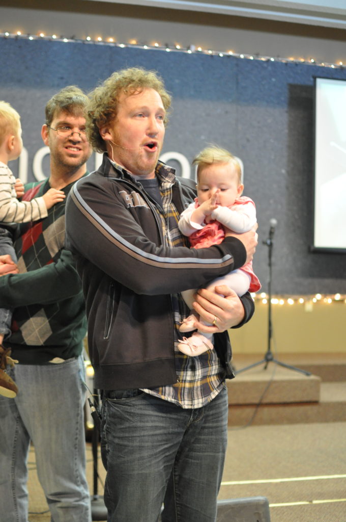 Chris Pacholczak holding a baby
