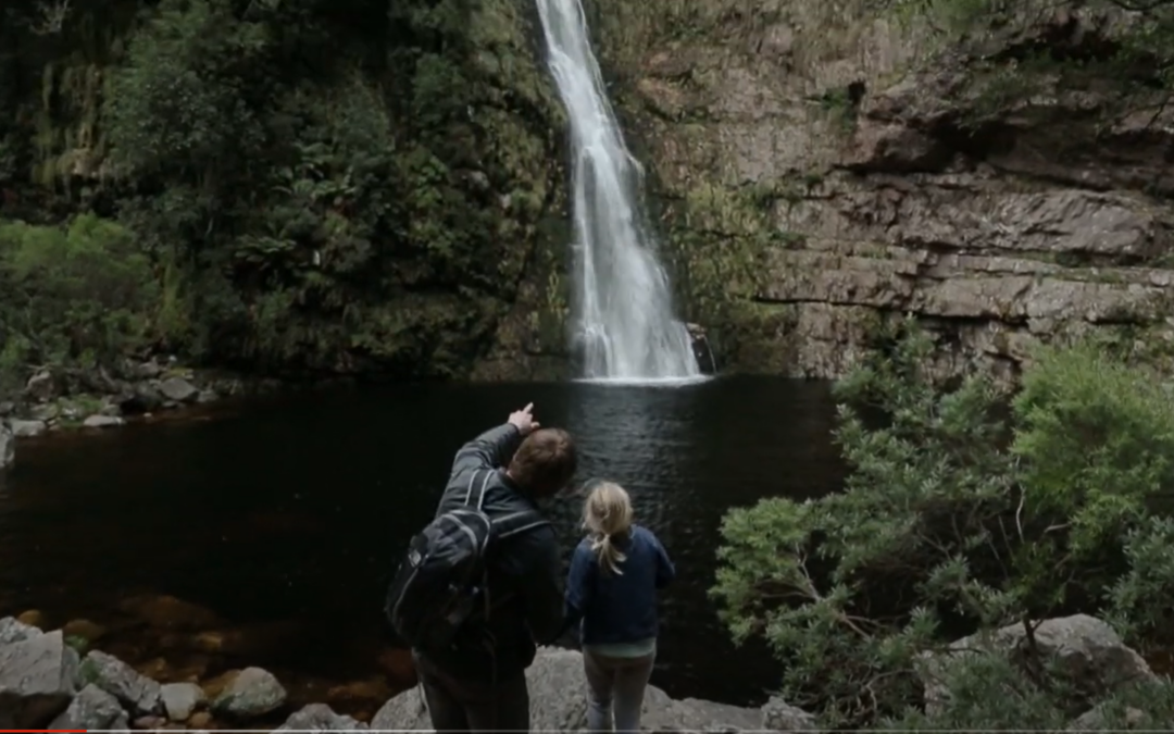 A Young Girl Capturing a Waterfall