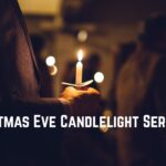 Man holding candle at Christmas eve service