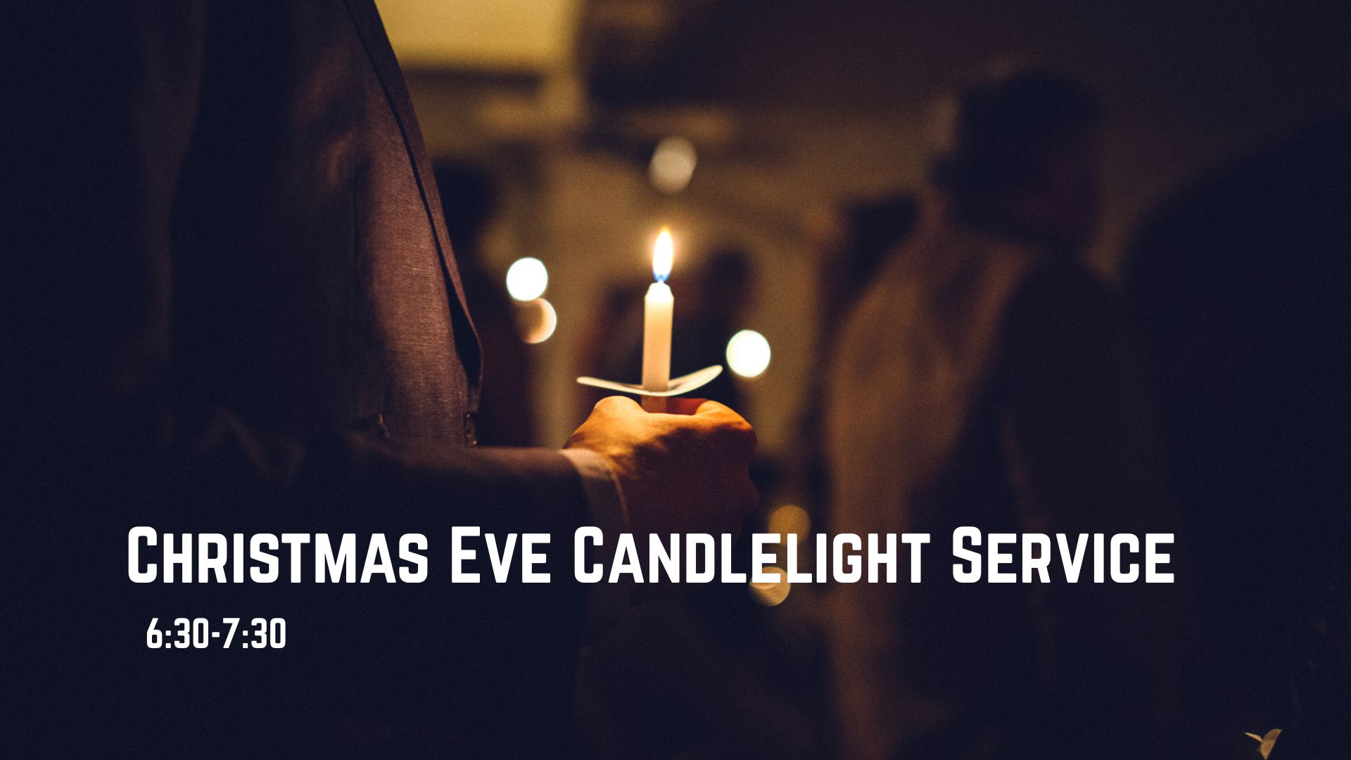 Man holding candle at Christmas eve service